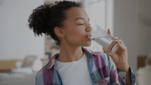 Girl-drinking-Clean-water-of-Iron-Filtration-in-Well-Water-Softener-System
